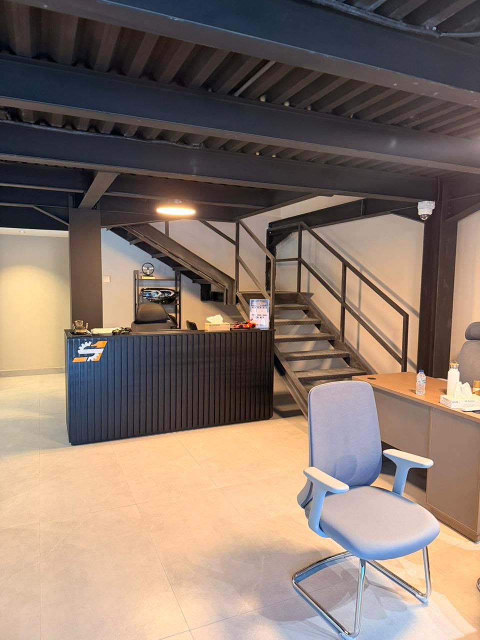 Mezzanine office with steel staircase and reception desk
